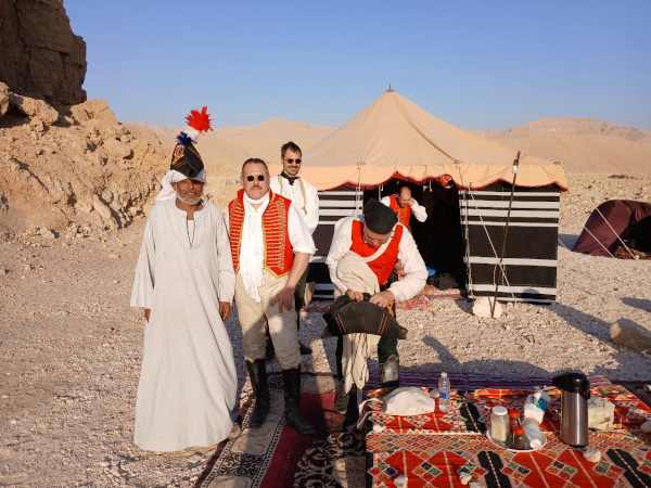 Tour guide with guests at desert camp