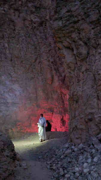 Tour guides in illuminated cave