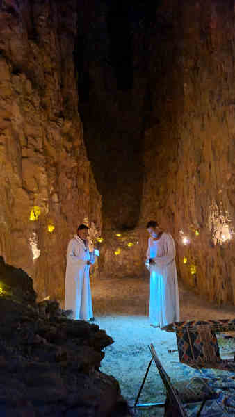 Tour guides in illuminated cave