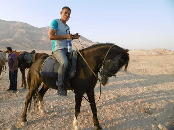 Tour guide on a horse in the desert